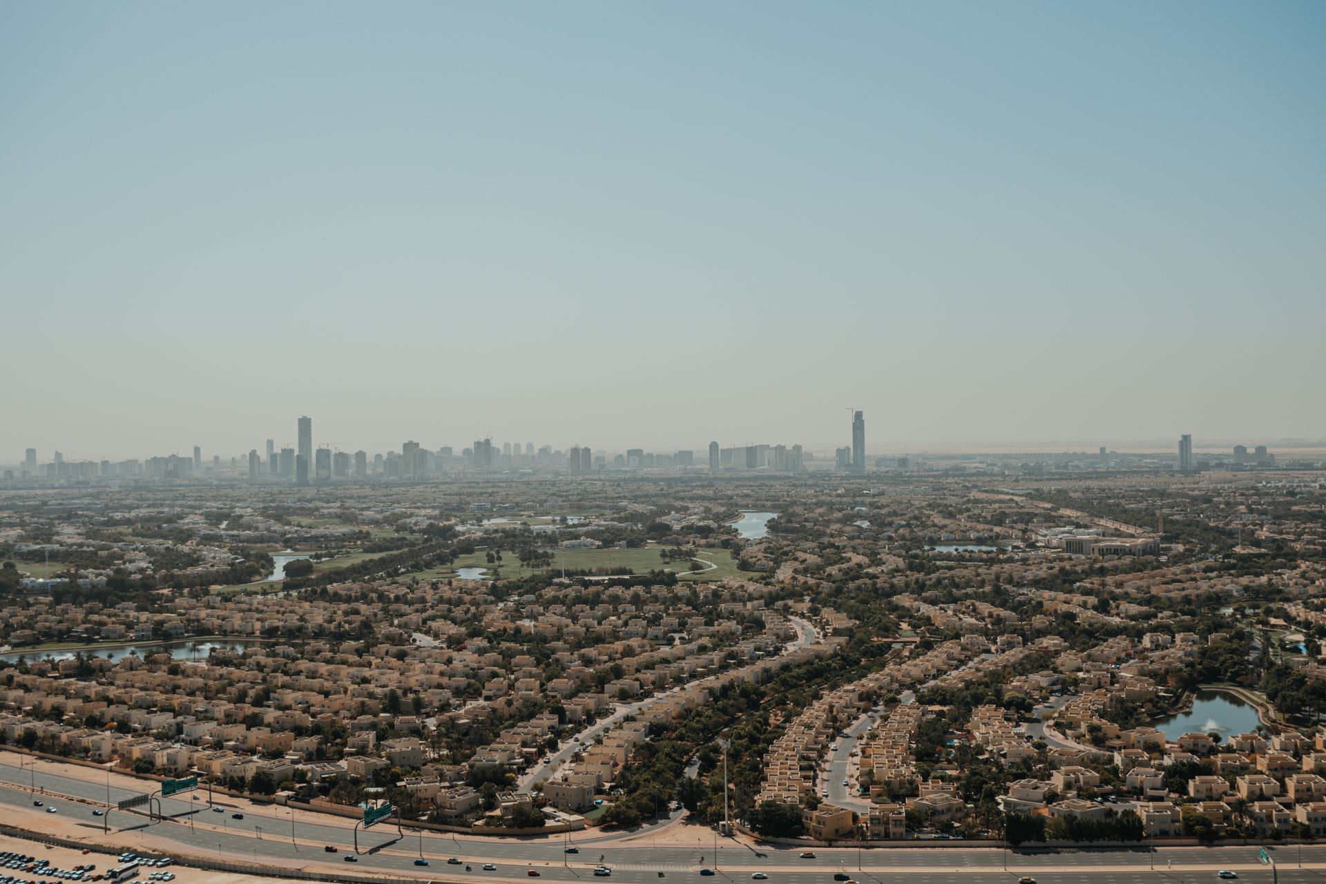 Explore the modern urban landscape of Dubai with its expansive residential areas and iconic skyline.