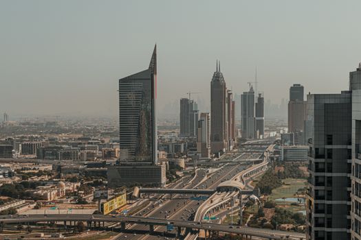 Stunning view of Dubai's skyline at dusk showcasing skyscrapers and highways in a futuristic urban landscape.