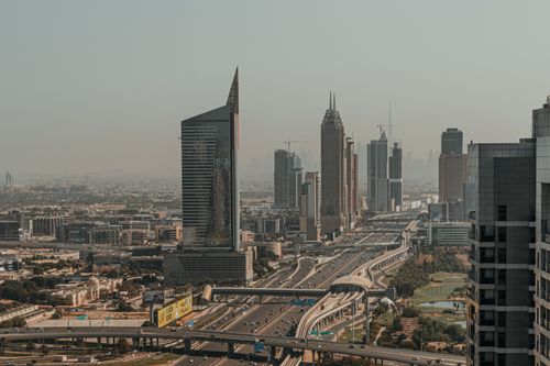 Free Stunning view of Dubai's skyline at dusk showcasing skyscrapers and highways in a futuristic urban landscape. Stock Photo