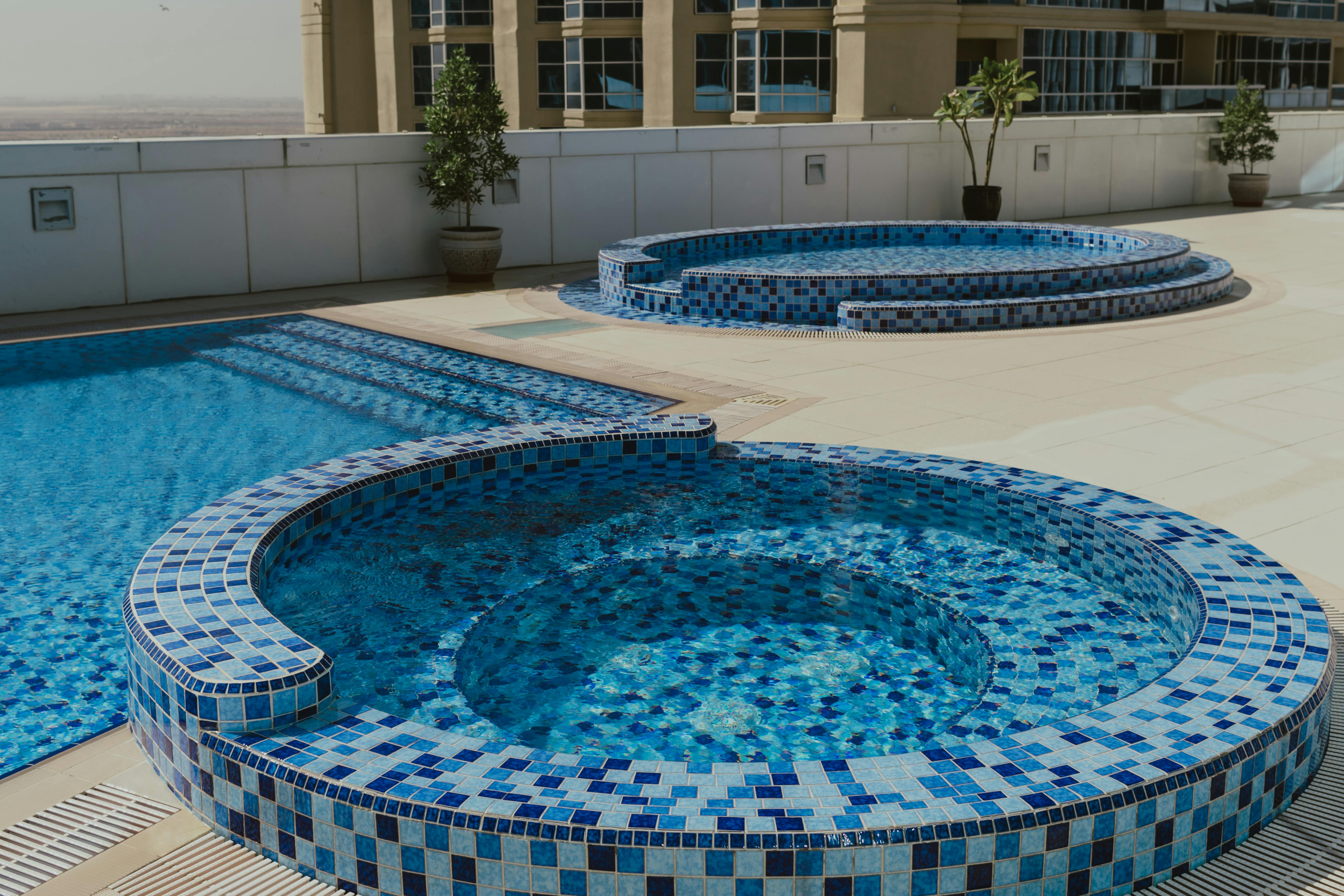 outdoor rooftop swimming pool with modern cityscape views