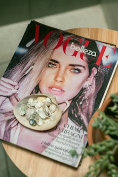 A Vogue magazine featuring a model, styled with seashells on a table.
