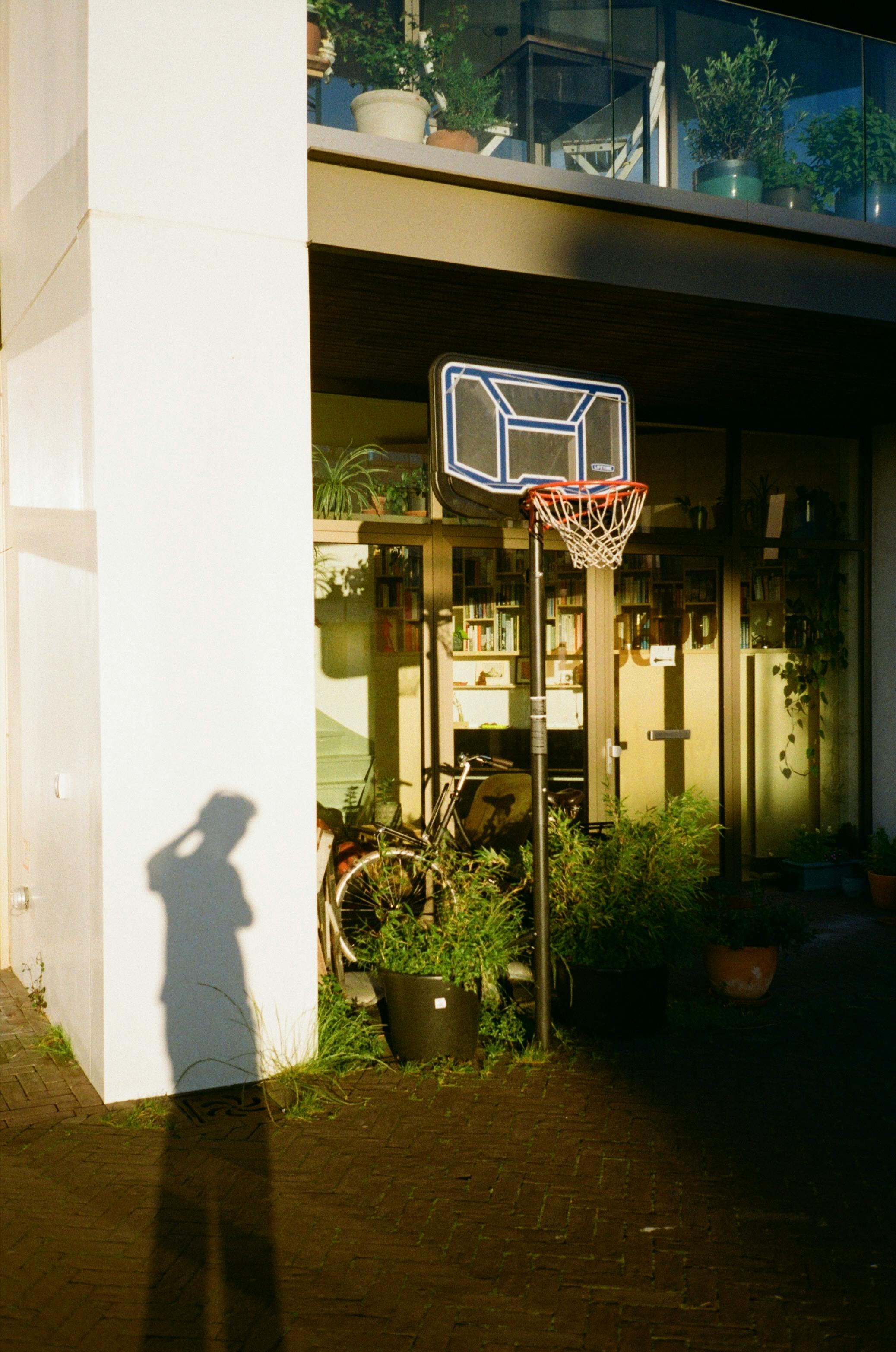 a shadow of a person standing in front of a building