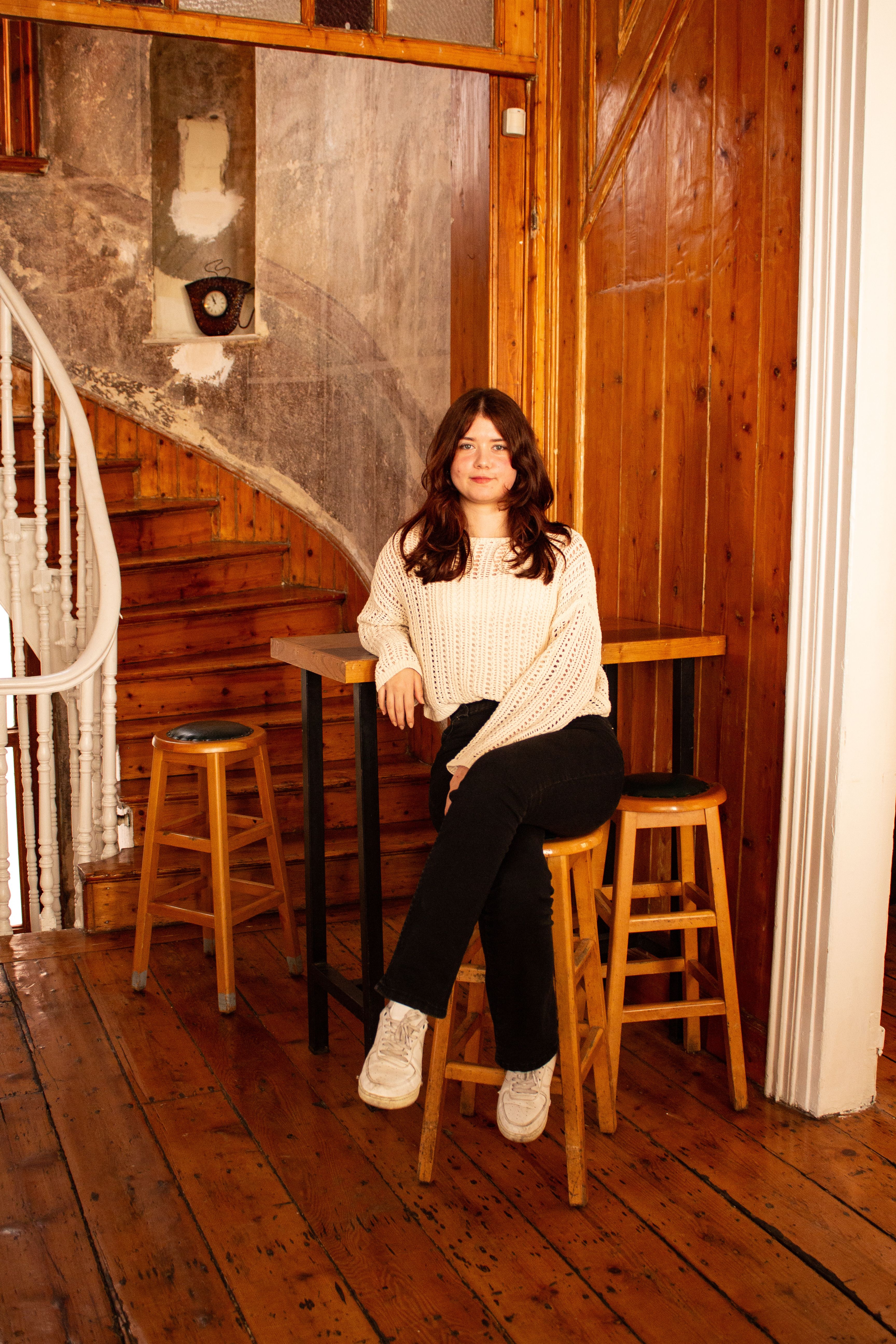 Portrait of a woman in a cozy wooden room with rustic decor. Ideal for lifestyle themes.