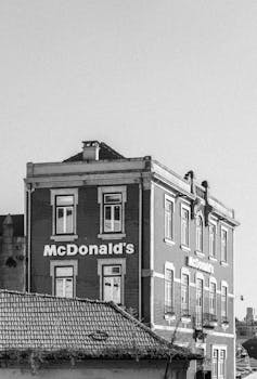 Black and white photo of a historic McDonald's building in Porto, Portugal.