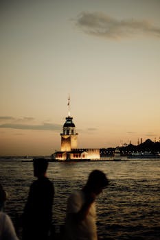 Silhouette of people by the Maiden's Tower in Istanbul during a beautiful sunset.