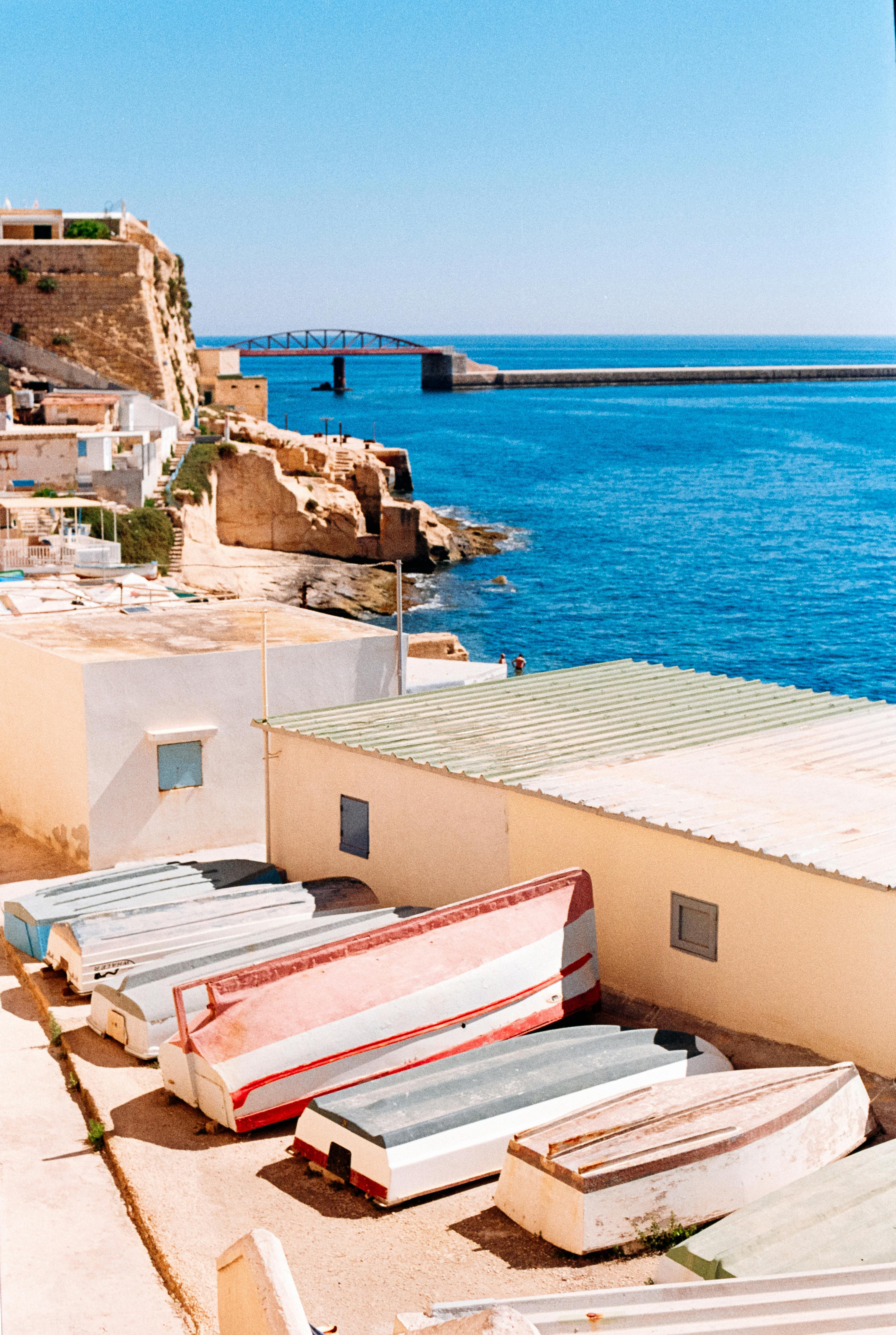 Colorful boats on a serene seaside, perfect for travel inspiration.