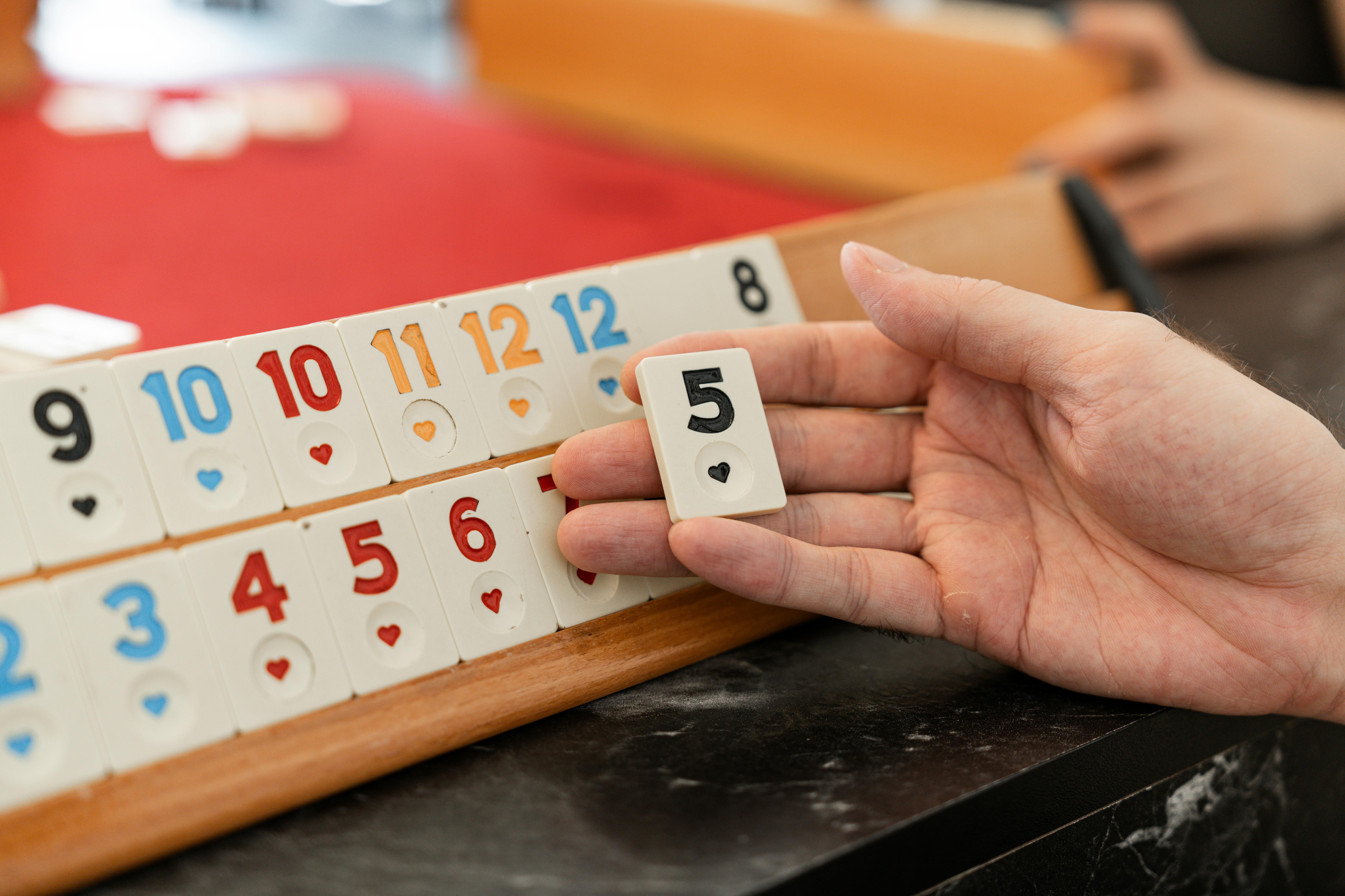 a person holding a hand with a deck of cards