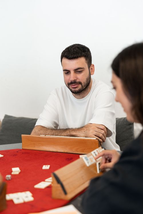 Free A group of young adults playing a board game indoors, showcasing leisure and togetherness. Stock Photo