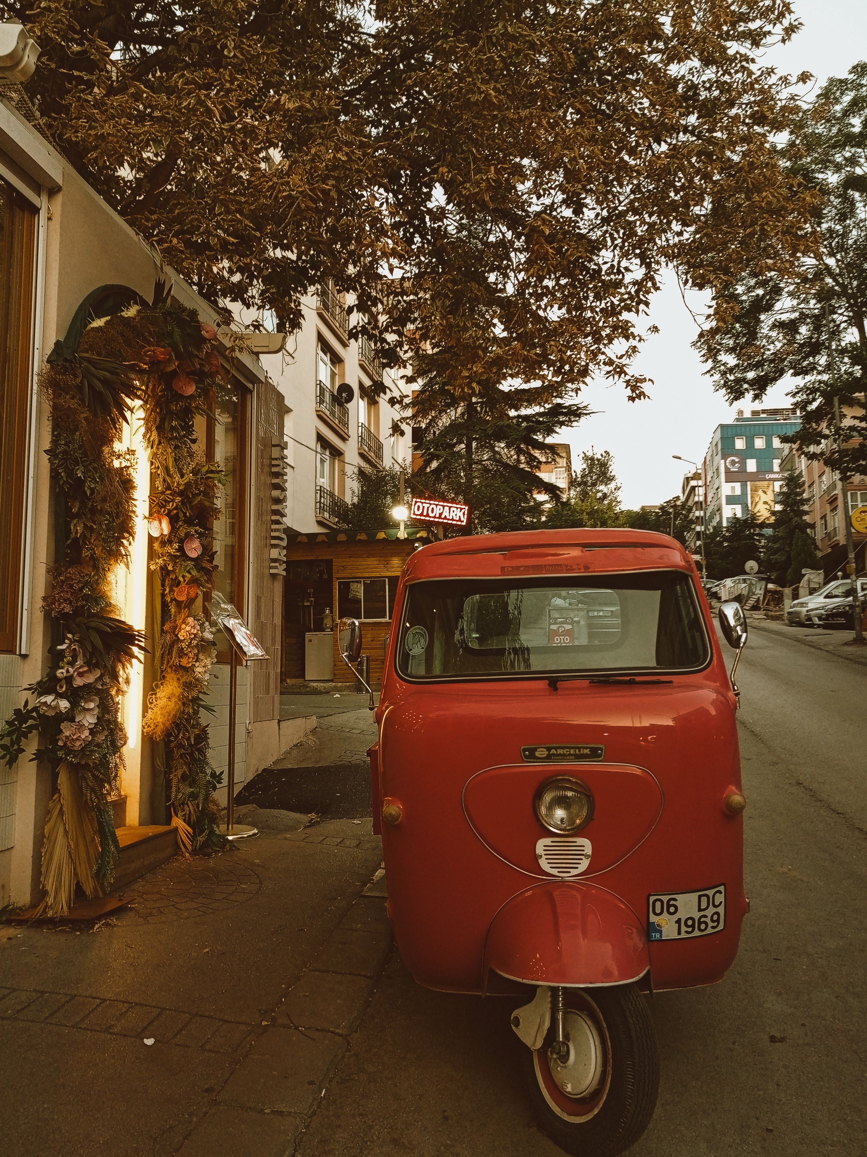 A red car parked on the side of a street · Free Stock Photo