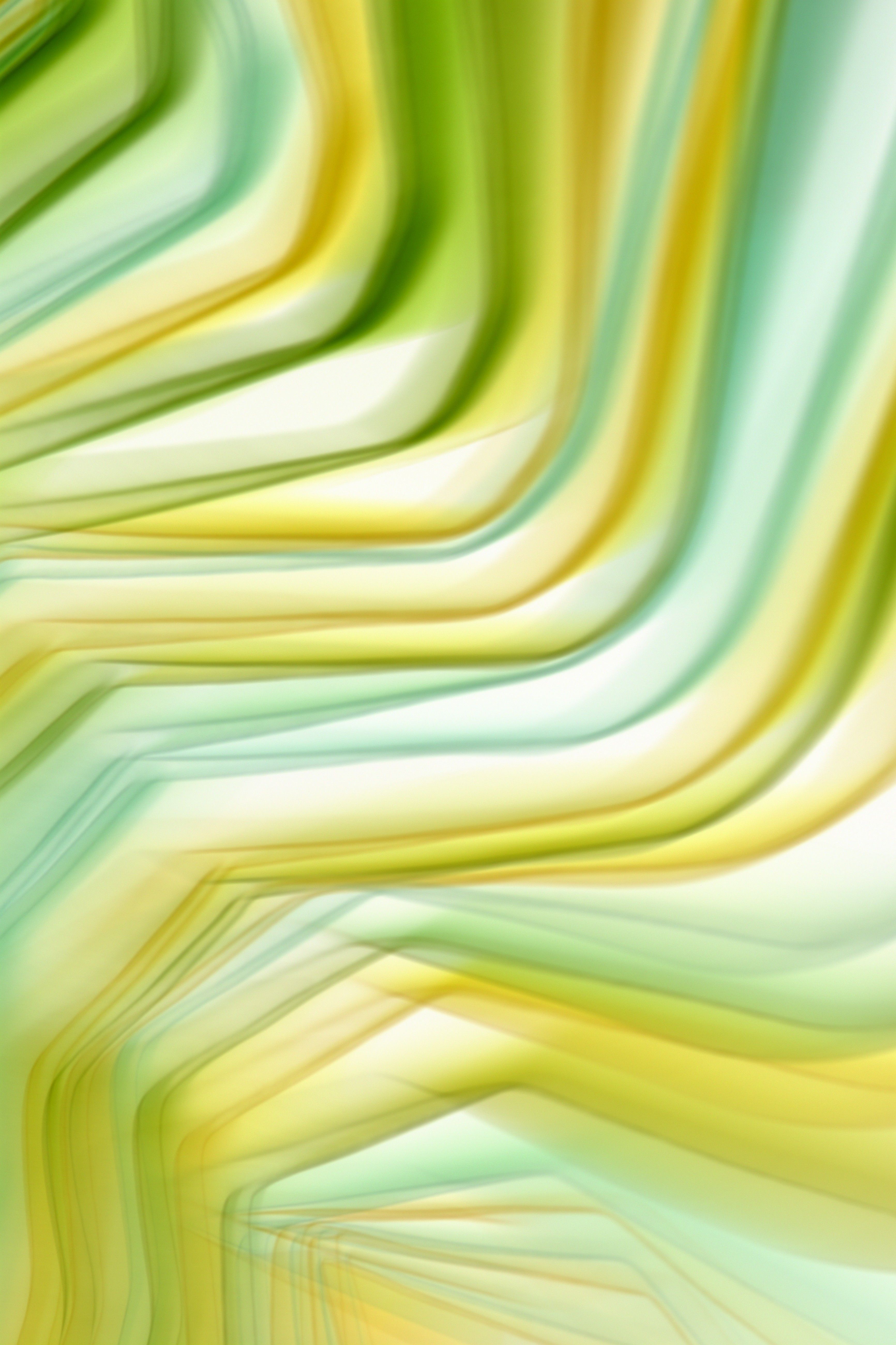 Abstract smooth waves in green and yellow tones creating a fluid, artistic background.