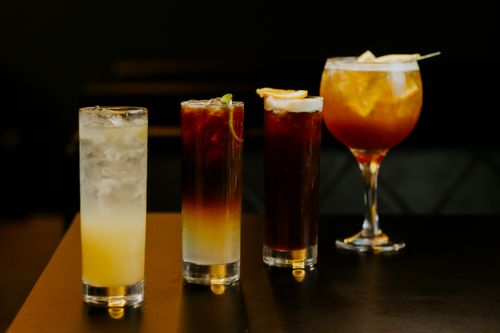 Free A stylish presentation of four chilled cocktails in various glasses, perfect for nightlife and social gatherings. Stock Photo