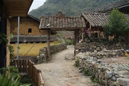 Free Explore rustic Vietnamese village architecture in Ha Giang featuring traditional wooden huts and stone pathways. Stock Photo