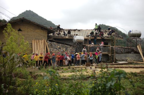 Free Locals participate in a communal house construction in rural Ha Giang, Vietnam. Stock Photo