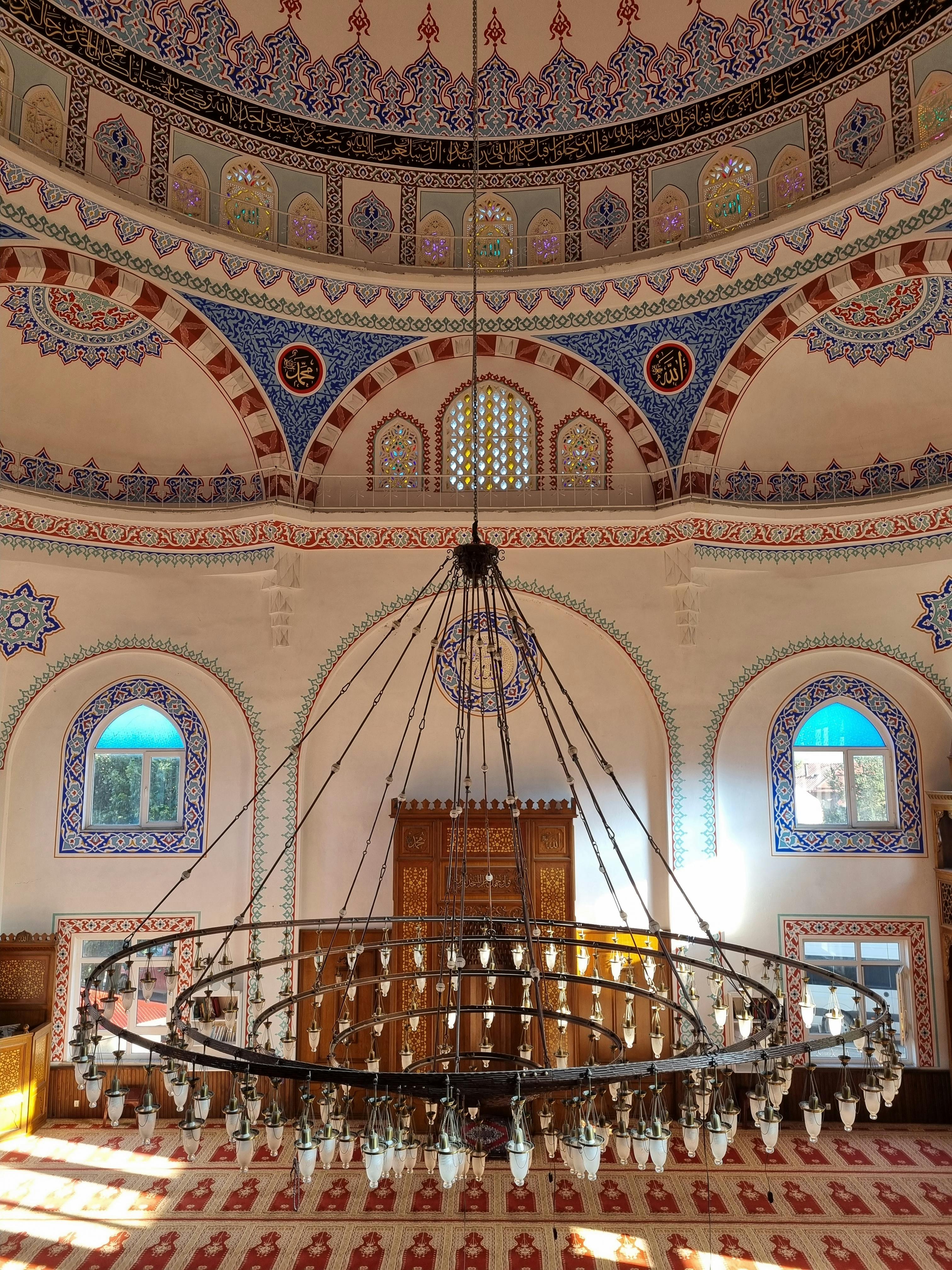 the interior of a mosque with a chandelier