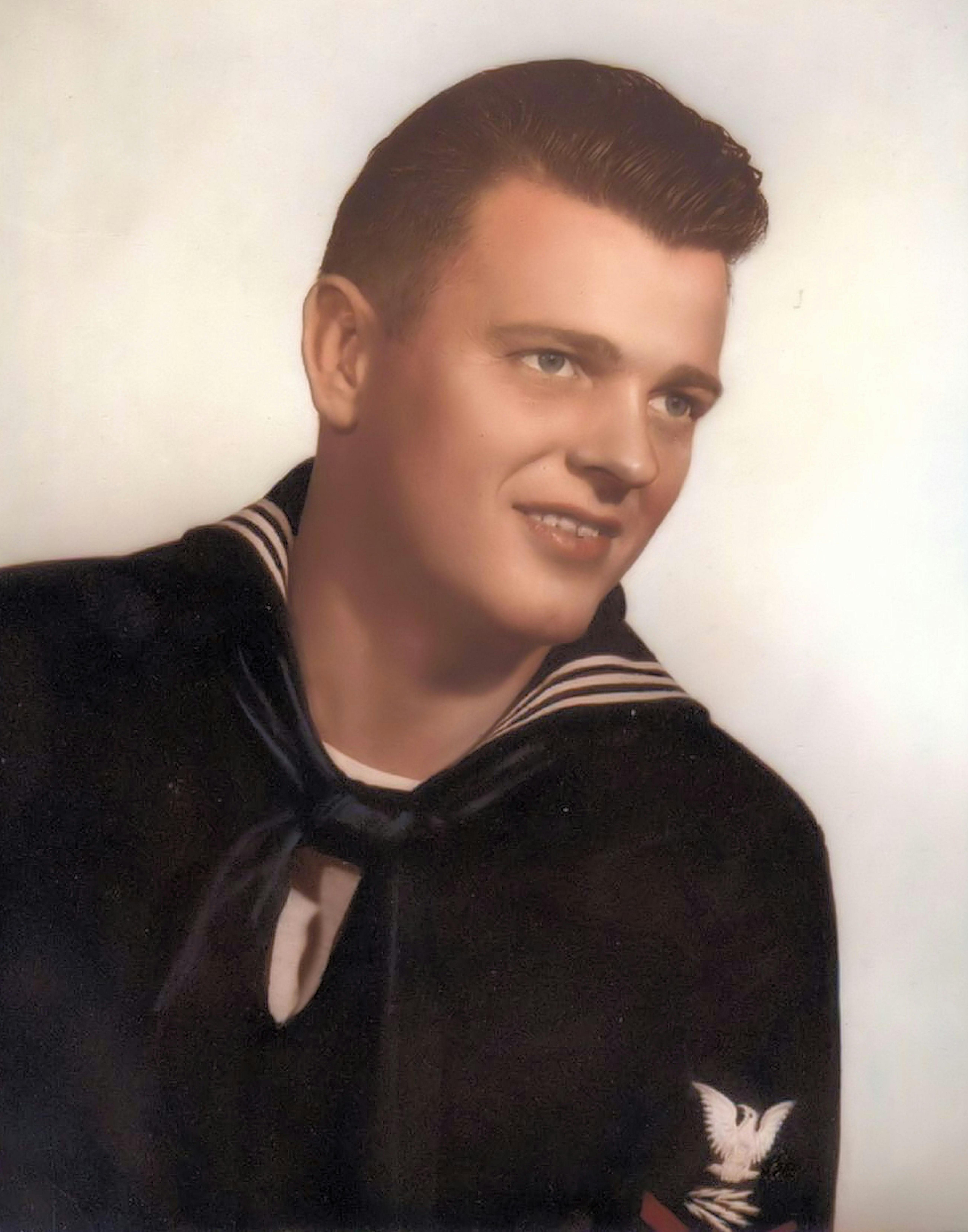 a vintage photo of a young man in a sailor uniform