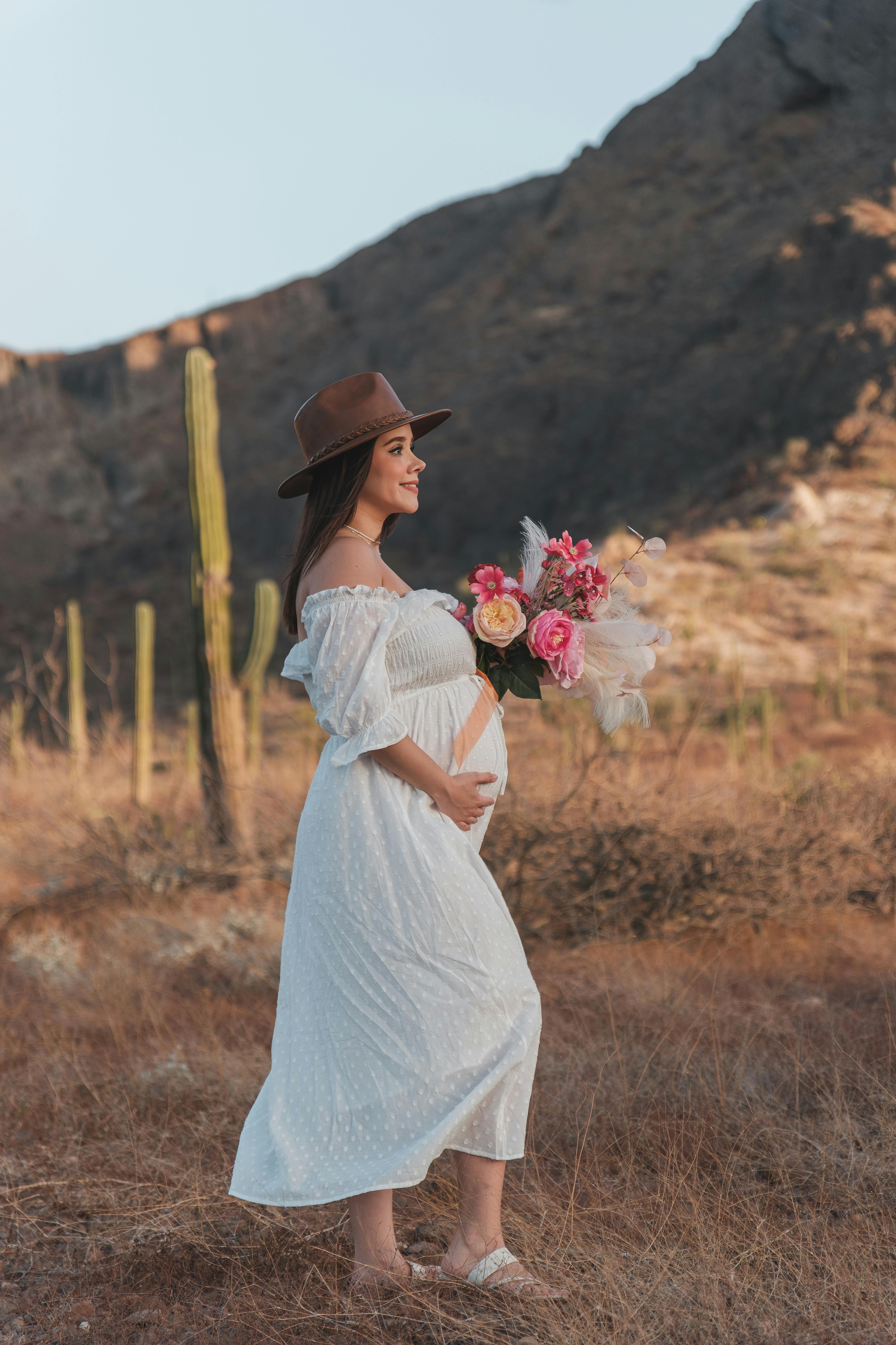 pregnant woman in hat and dress