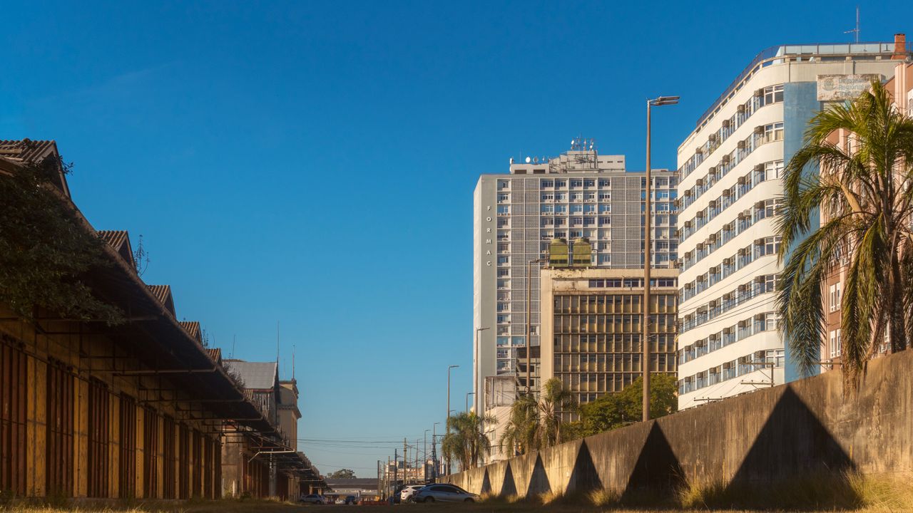Cityscape view of Porto Alegre showcasing modern buildings under a clear blue sky.