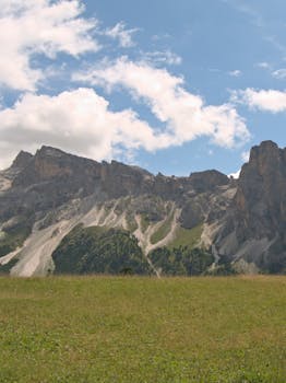 Scenic view of the rugged Dolomites with lush green foreground in Santa Cristina Valgardena, Italy.