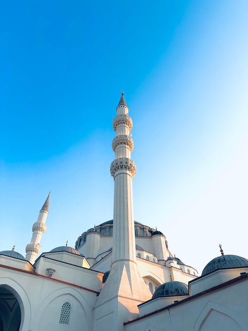 Free Stunning view of a mosque with minarets under a clear blue sky in Sharjah, UAE. Stock Photo