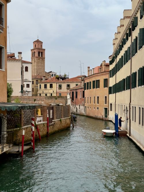 Free Explore a peaceful Venetian canal surrounded by charming historic buildings. Stock Photo
