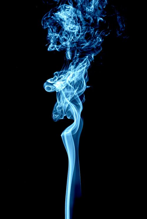 Free Dynamic trails of blue smoke create an abstract and mysterious visual. Stock Photo