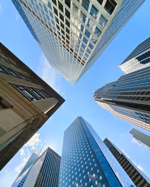 Free Upward view of towering skyscrapers in New York City, capturing the modern urban atmosphere. Stock Photo