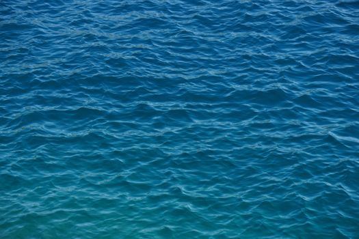 A tranquil view of the azure ocean with gentle ripples creating a serene pattern on the water's surface.