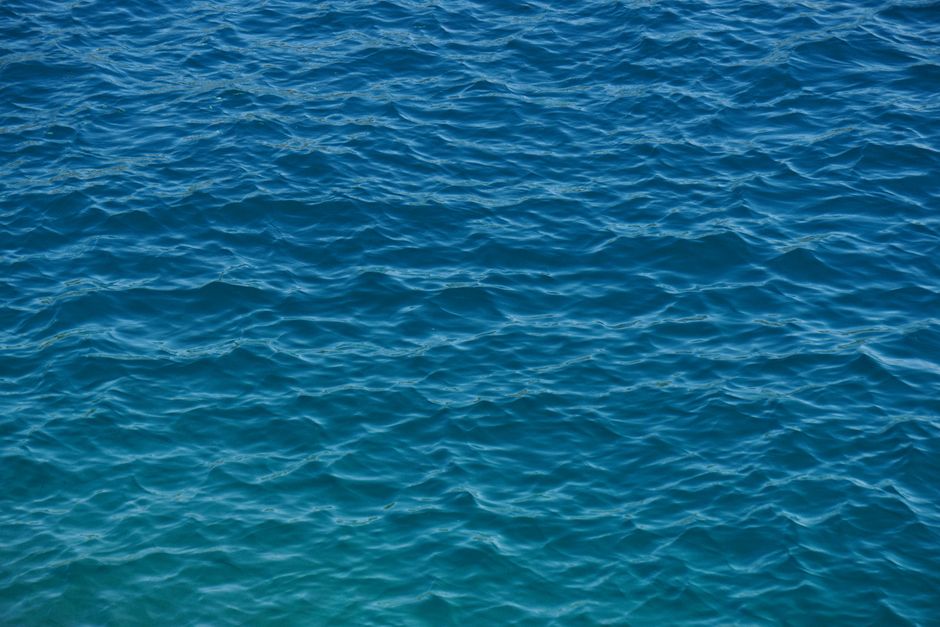 A tranquil view of the azure ocean with gentle ripples creating a serene pattern on the water's surface.