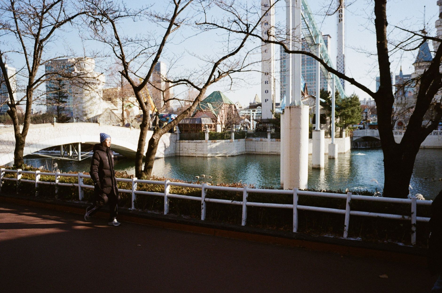 A person walks along a winter path overlooking Lotte World in Seoul, South Korea.
