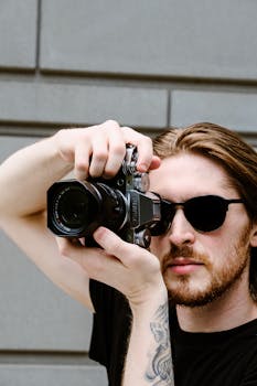 Portrait of a man photographing in an urban environment, showcasing creativity.