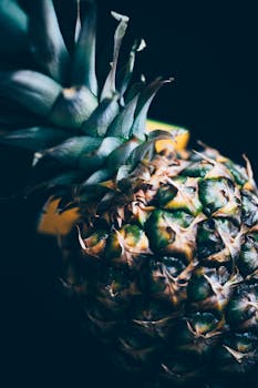 High-quality close-up of a fresh and organic pineapple, showcasing its tropical texture and vibrant colors.