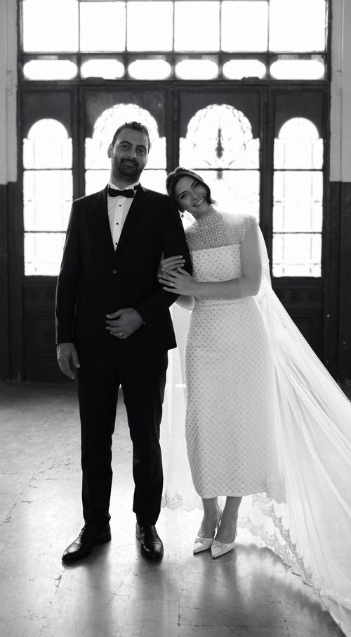 Free Black and white portrait of a bride and groom standing indoors, exuding elegance Stock Photo
