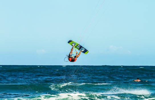 Dynamic kitesurfing action captured on the beautiful coast of Brazil under bright summer skies.