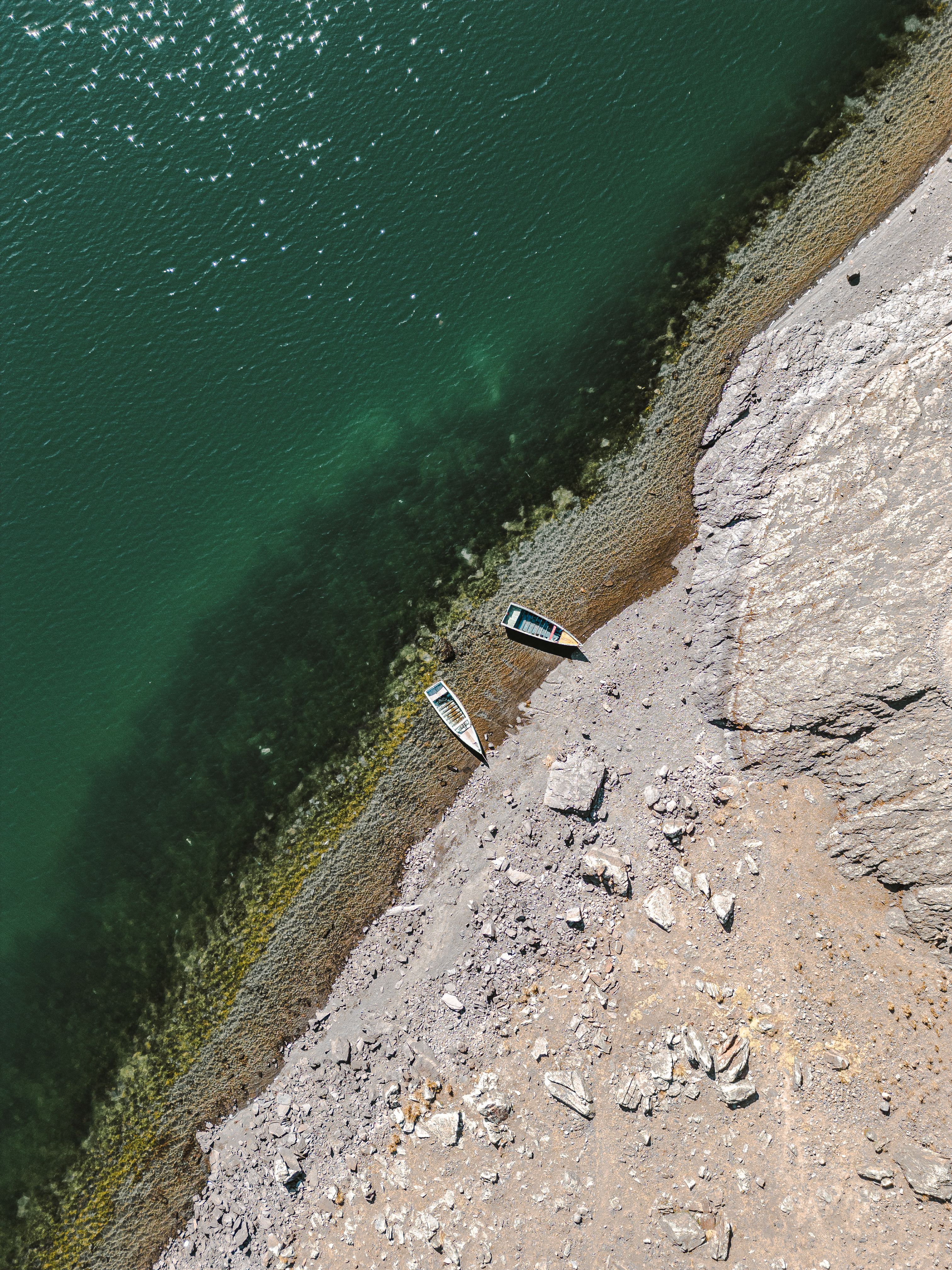 Aerial View of Boats on a Rocky Seashore · Free Stock Photo