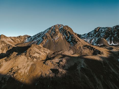 A stunning view of the rugged mountain landscape in Condoriri, Bolivia, showcasing snow-capped peaks under a clear sky.