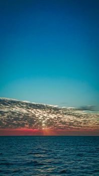 Breathtaking sunset view over the calm ocean in Zanzibar, Tanzania, capturing the beauty of the sky and sea.