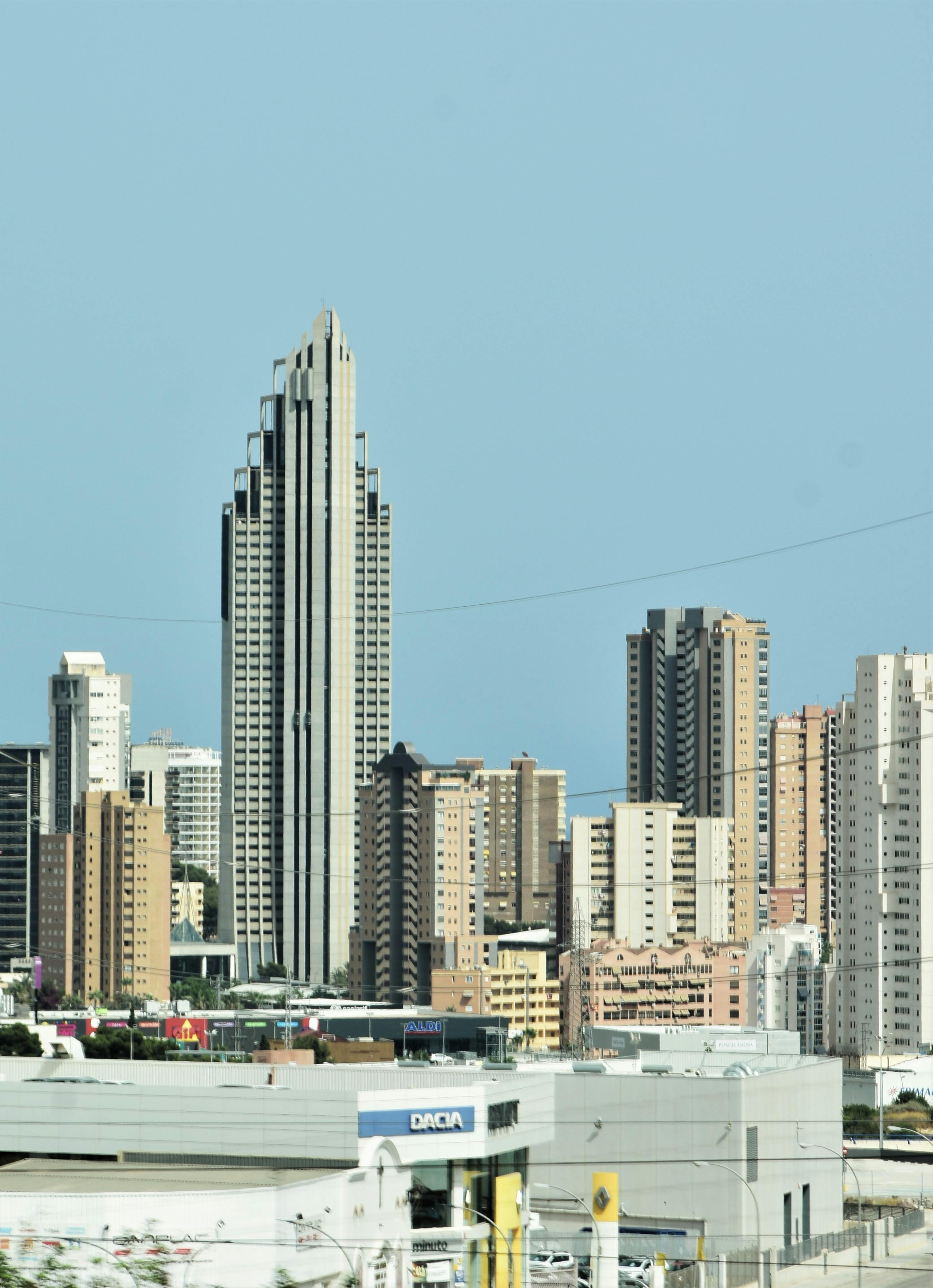 Beautiful urban cityscape featuring modern skyscrapers and a clear blue sky.