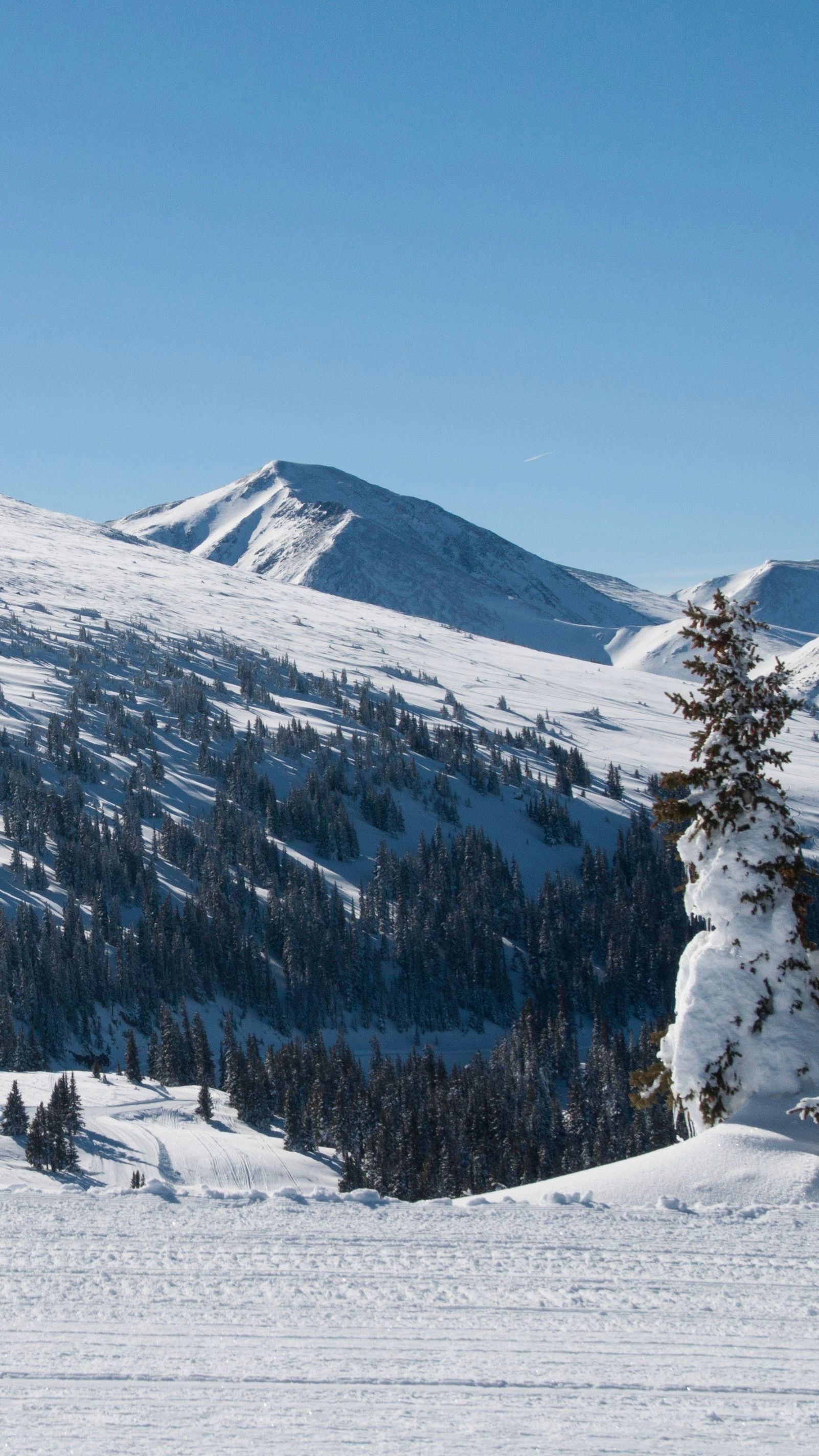 Scenic snowy mountain view in Winter Park, Colorado, on a bright winter day.
