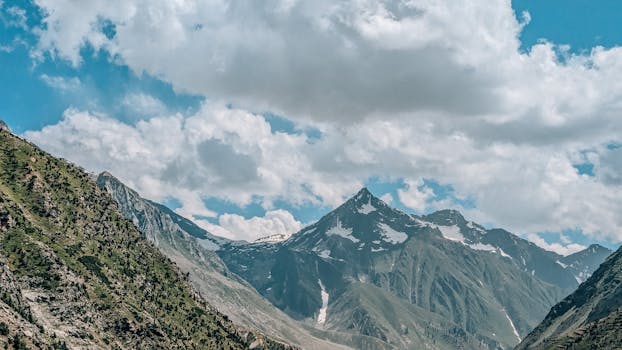 Capture of majestic mountains and blue skies, perfect for adventure and travel themes.