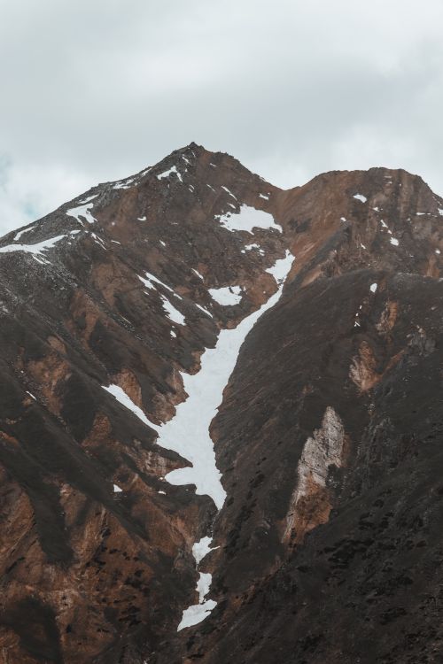 Free A stunning mountain landscape with snow-capped peaks and rocky formations, perfect for adventure seekers. Stock Photo