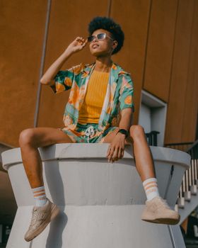Fashionable person in colorful summer outfit posing outdoors in Berlin