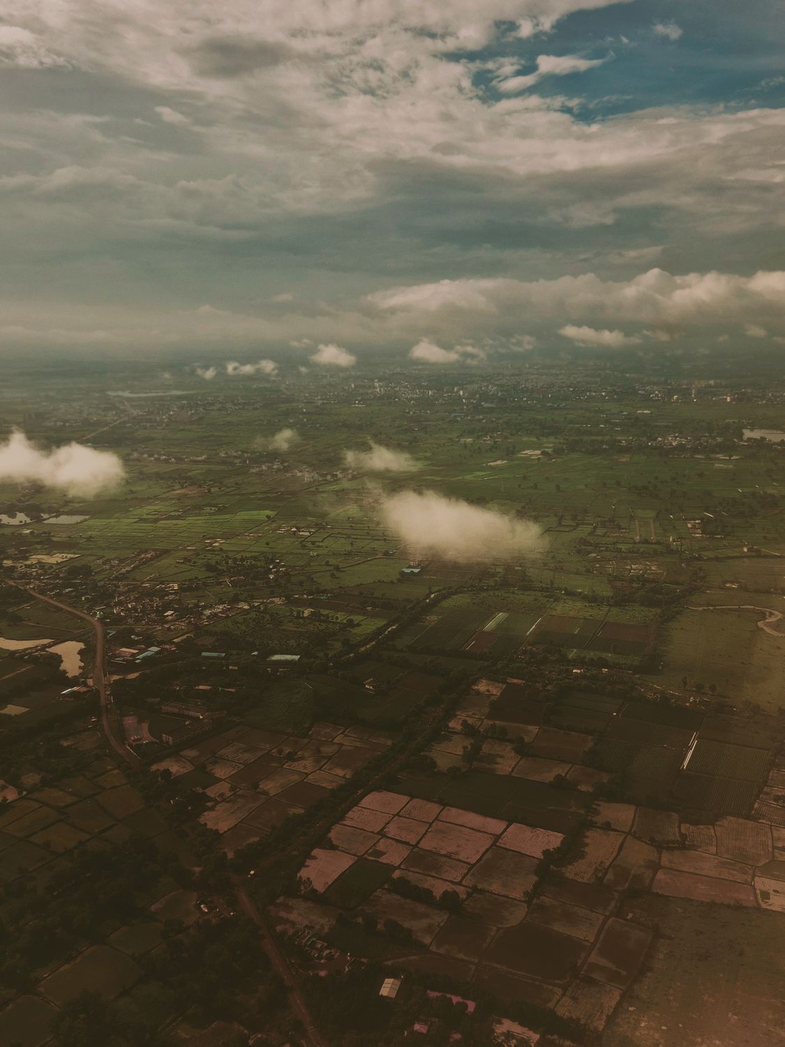 Aerial View of a City and Clouds from an Airplane · Free Stock Photo