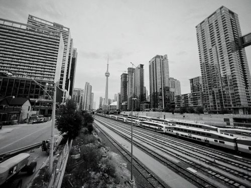 Free Monochrome view of Toronto skyline with train tracks and urban buildings. Stock Photo