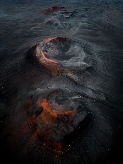 Stunning aerial view of volcanic craters in Rangárþing ytra, Iceland, showcasing vibrant earthy tones.