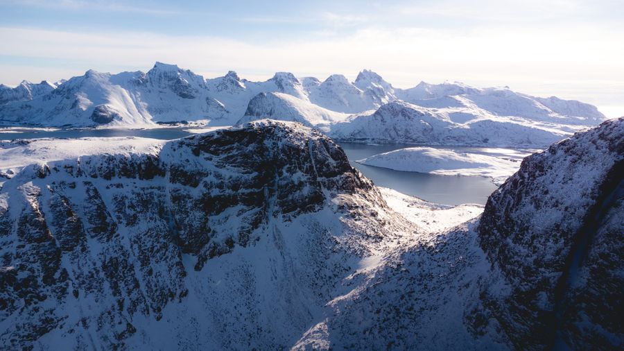 Aerial view of snow-covered mountains above fjords. Photo by Tomáš Malík on Pexels