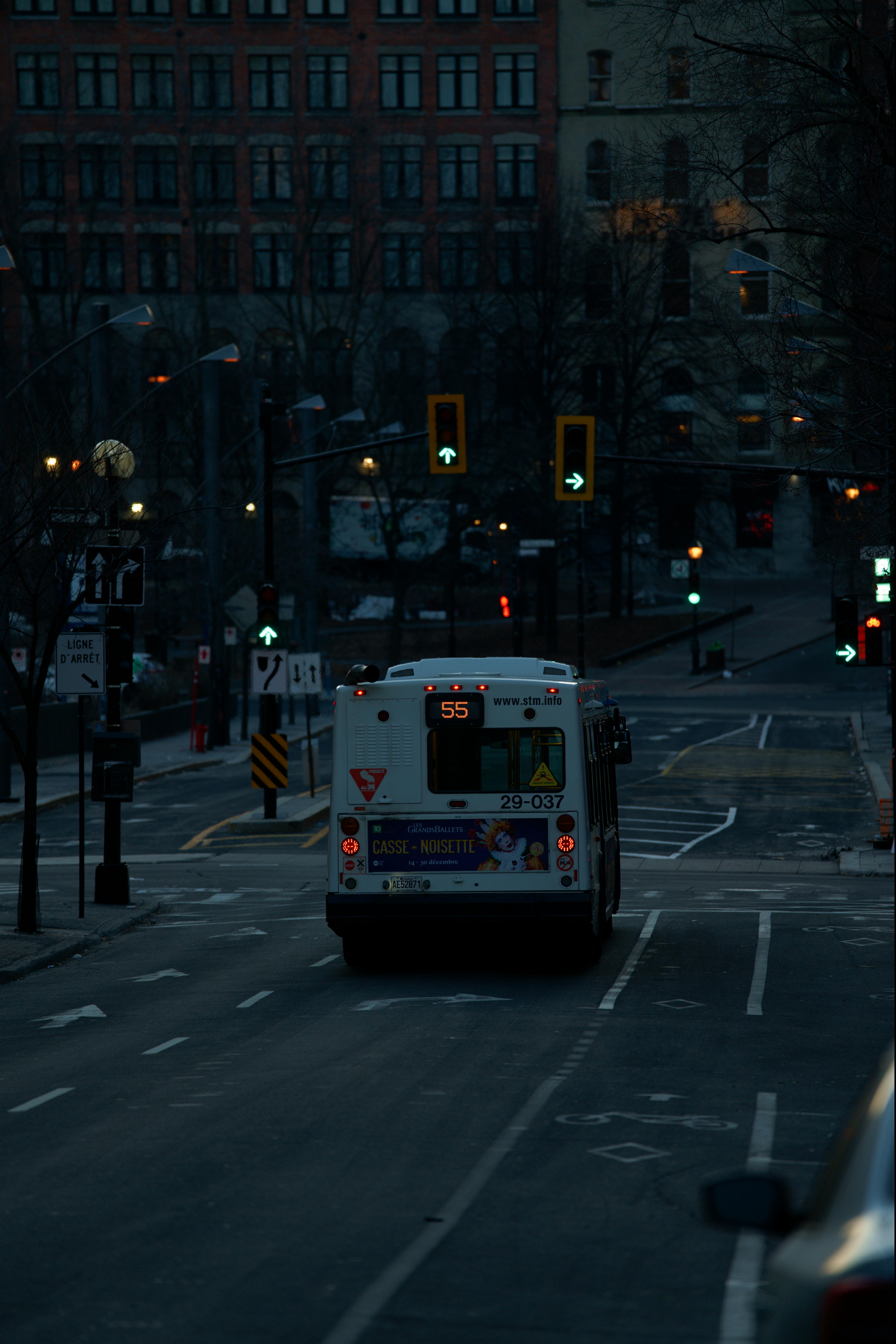 Free A city bus travels through a quiet Montreal street early in the morning. Stock Photo