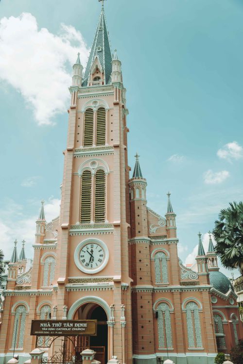 Free Capture of the iconic Pink Tan Dinh Church against a clear blue sky in Ho Chi Minh City, Vietnam. Stock Photo