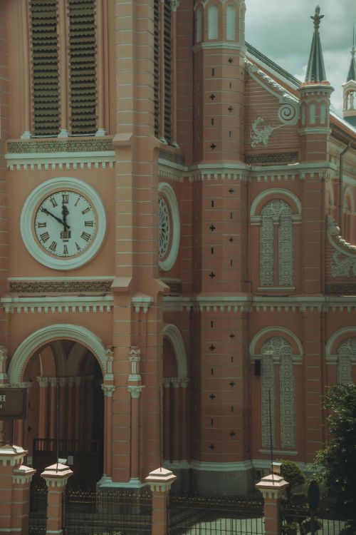 Free Close-up of the iconic pink Gothic architecture of Ho Chi Minh City's Notre Dame Cathedral. Stock Photo