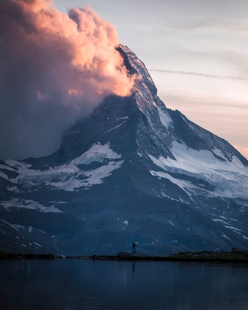 Фотография человека, стоящего через гору