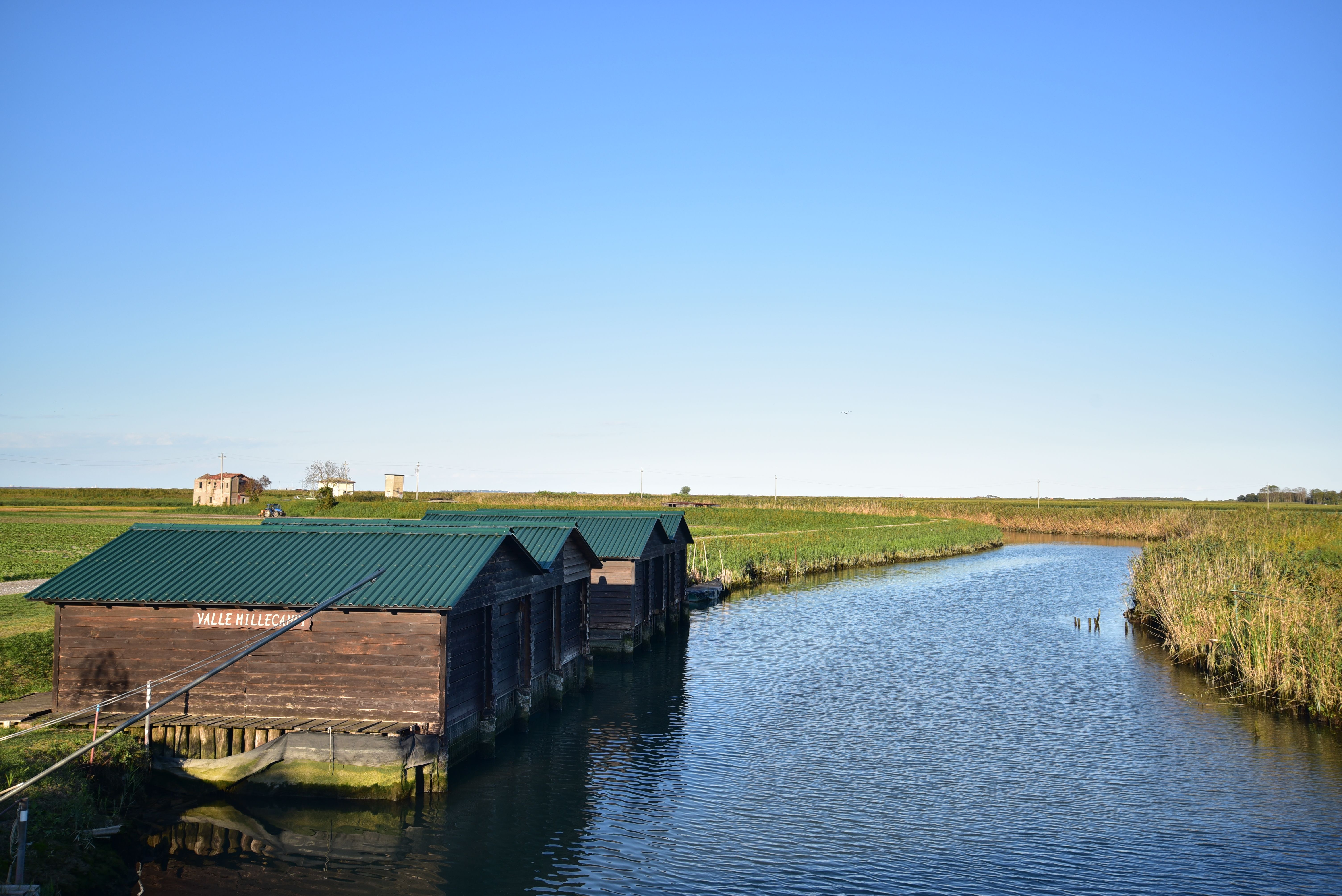 Wooden Houses by River in Countryside · Free Stock Photo
